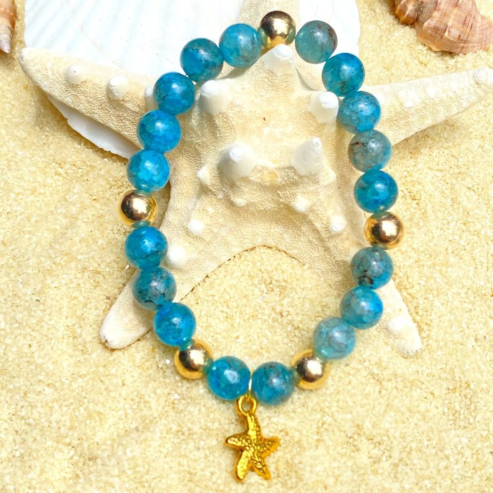 Beaded bracelet - blue and gold tone with starfish
